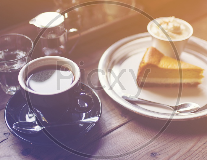 Coffee in Black Cup and cake, vintage filter image