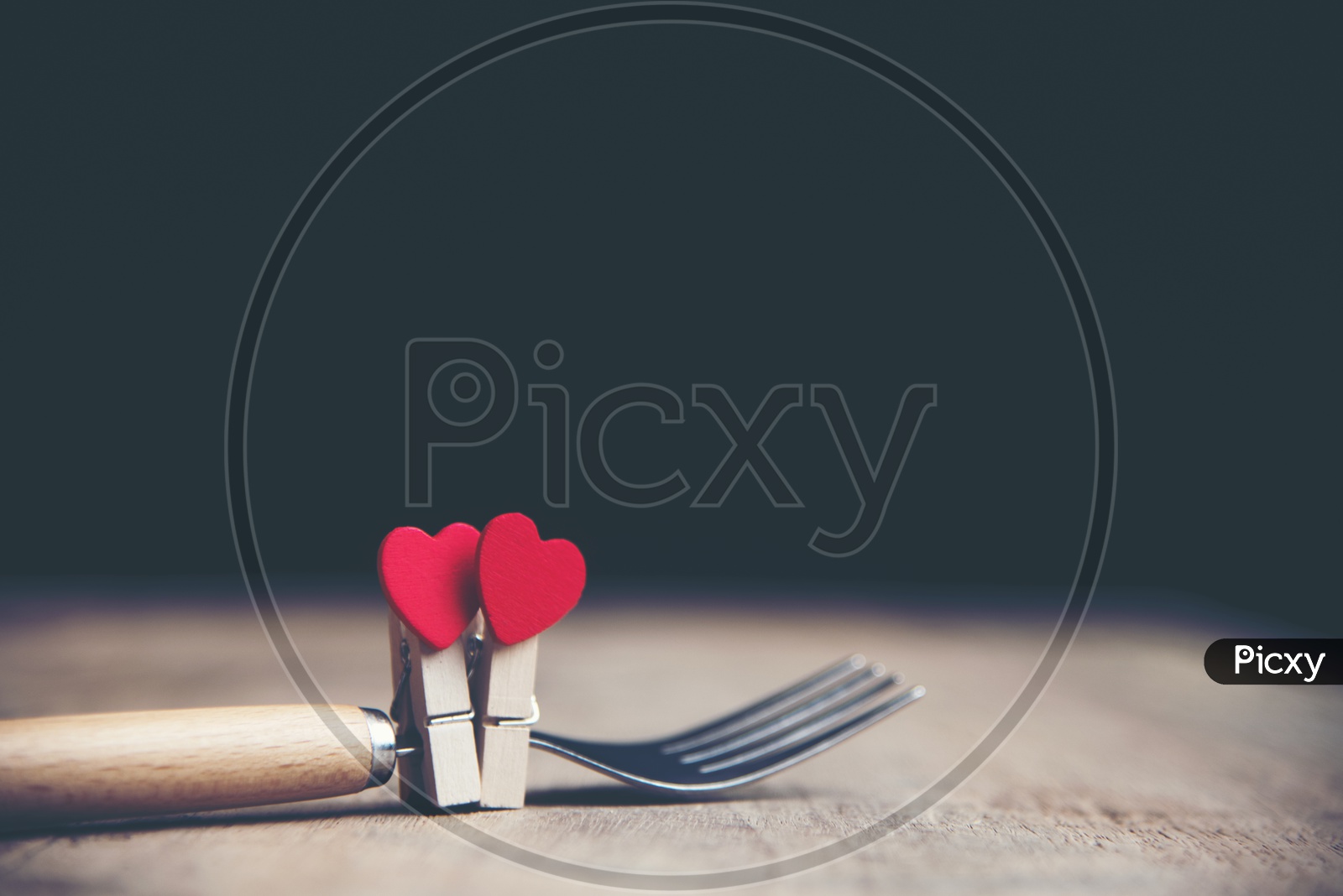 Heart Shape Couple Tagged  To a Fork  On a  Isolated Black Background  With vintage Filter