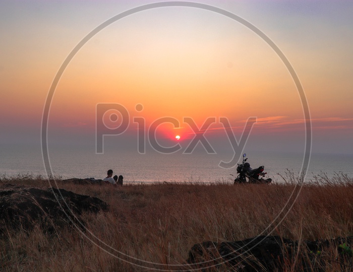A Lone Man With Sunset View from a hill Top