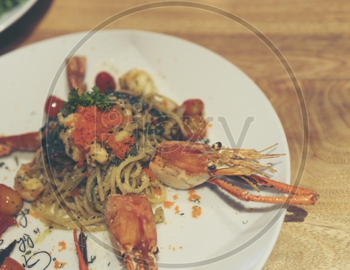 Spicy Spaghetti With Shrimp Served in a Restaurant Table