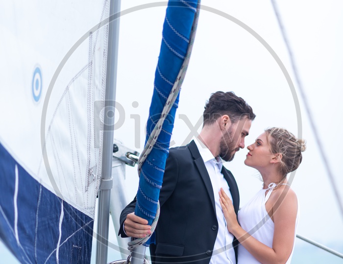 Young Couple Celebrating Wedding Anniversary in a yacht, Honeymoon Trip
