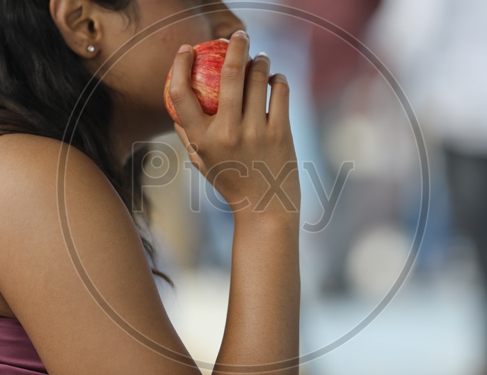 Indian Woman holding an Apple