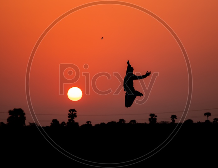 Young Man Jumping In Happy Or Joy Silhouette
