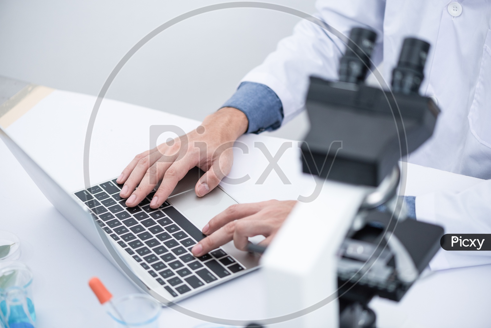 Asian Man working on Laptop at Laboratory