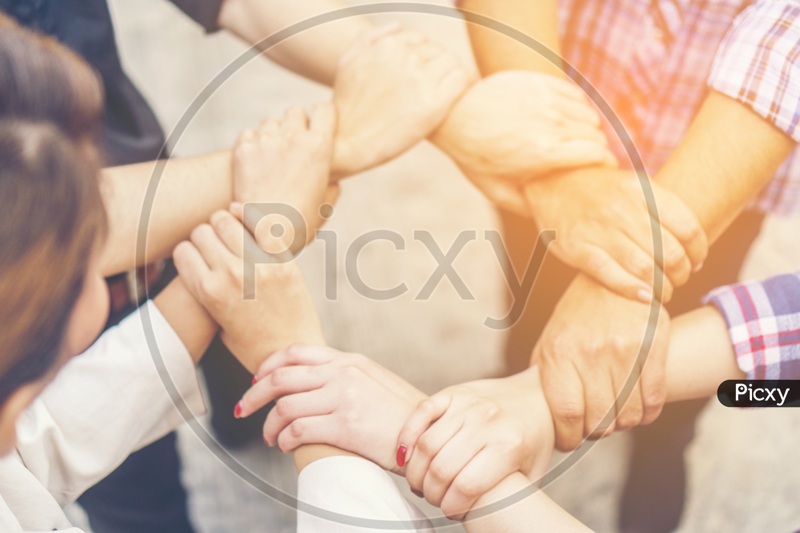 Group of business people crossed arms in pile for win