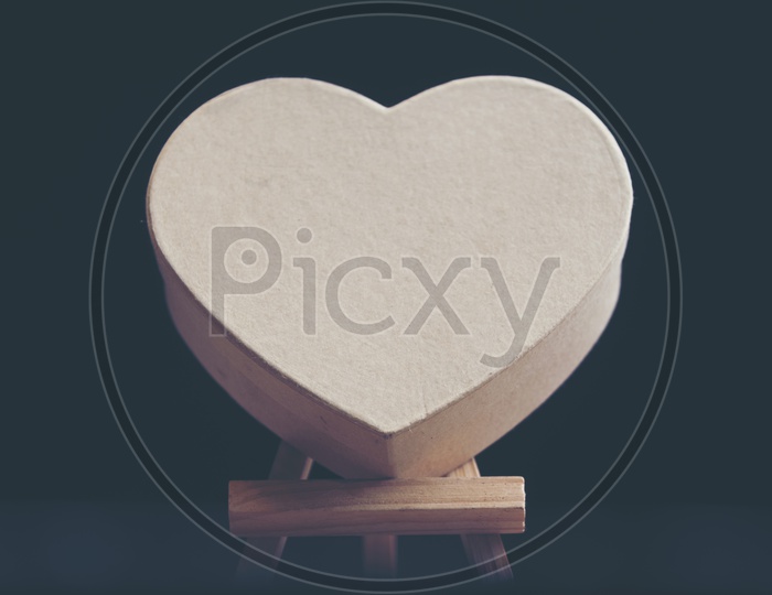 Heart shaped wooden block with black background