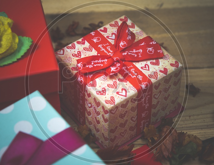 Gifts box on wooden table background - abstract picture for Valentine day, vintage filter image