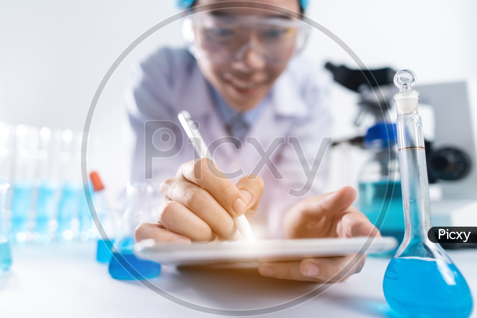 Asian Woman Scientist or Medical Student Working on her iPad at Laboratory