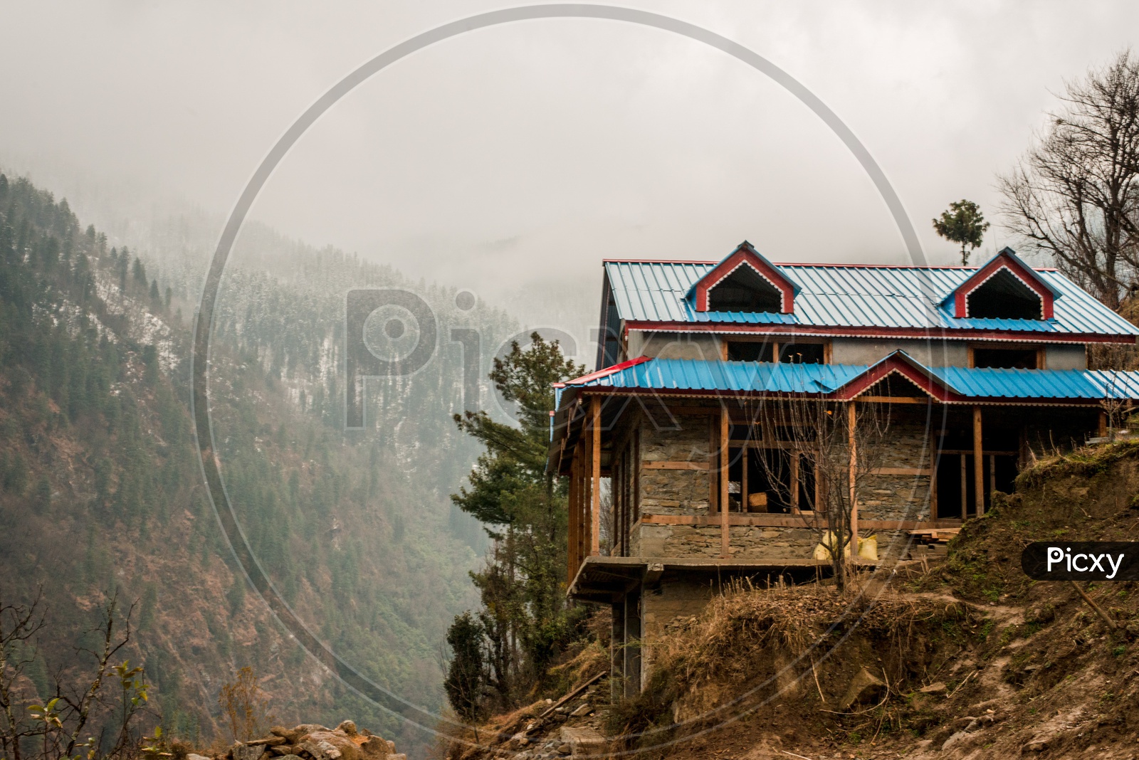 Typical wooden alpine house with Mountains in Background at the Himalayas