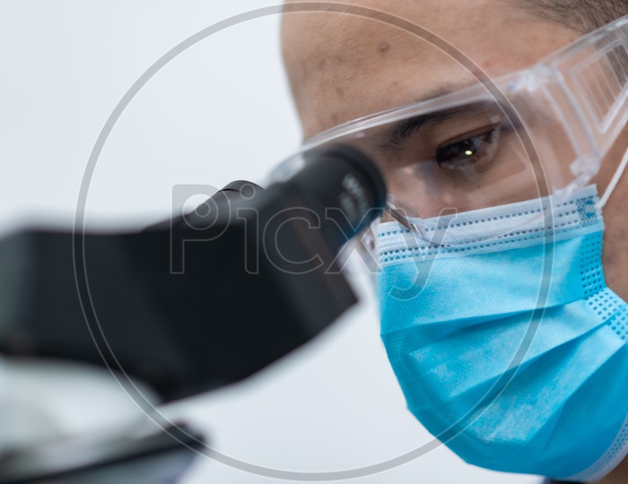 Closeup Shot of Asian Male Scientist Looking on Microscope