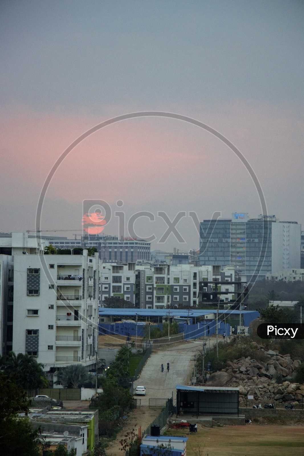 Sunset Over Buildings With Street Views