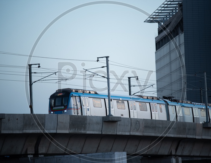 Metro Train Running On track With trident Hotel In Background