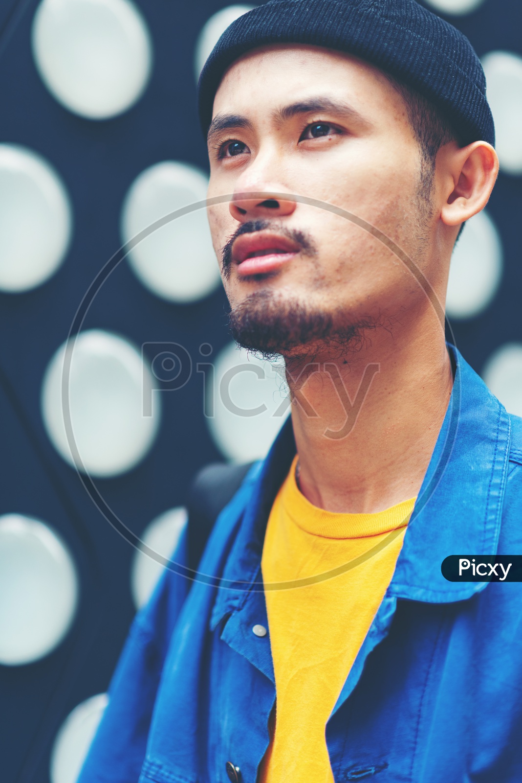 Image of A Hong Kong Man with stubble beard wearing colorful clothes