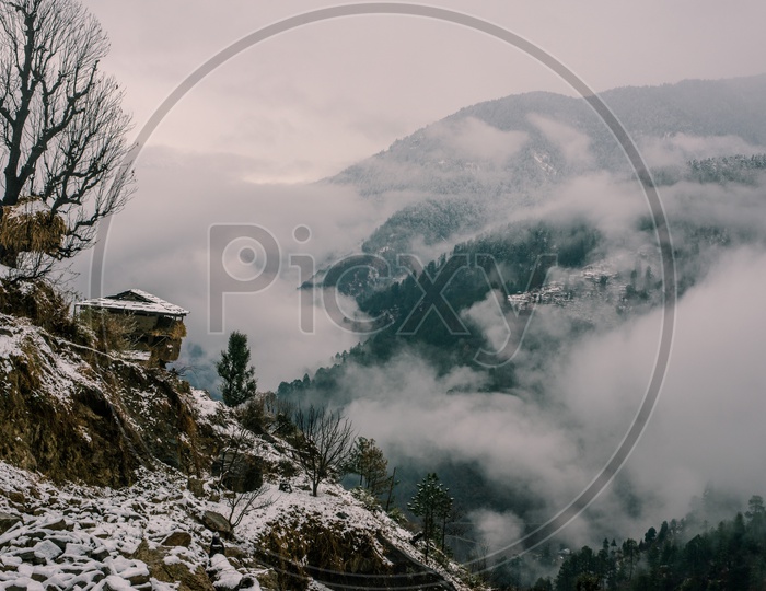 Landscape With Snow Covered Valley and Fog Clouds in Himalayas