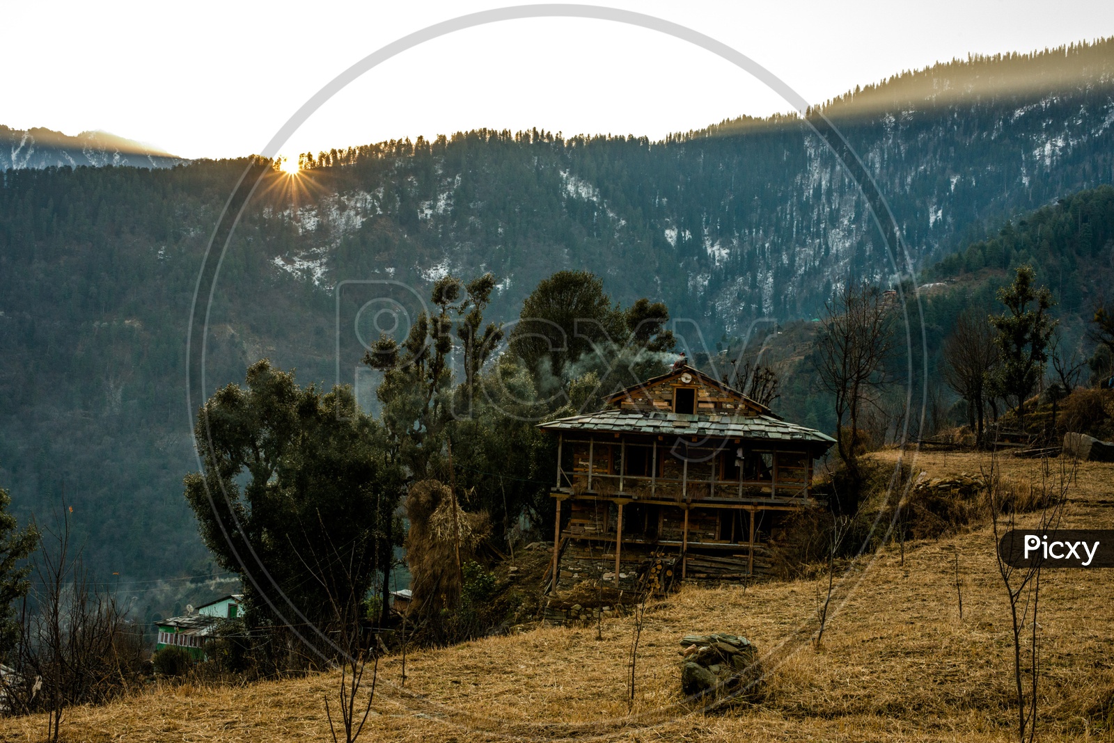 Typical wooden alpine house in himachal in himalayas With Mountains In Background