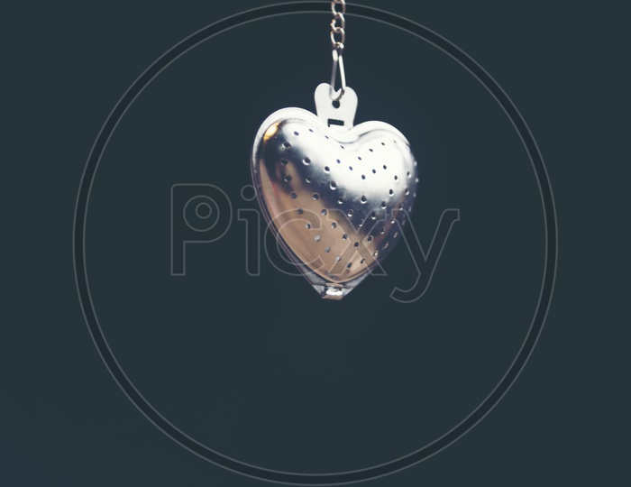 Heart shaped stainless steel locket side view with black background