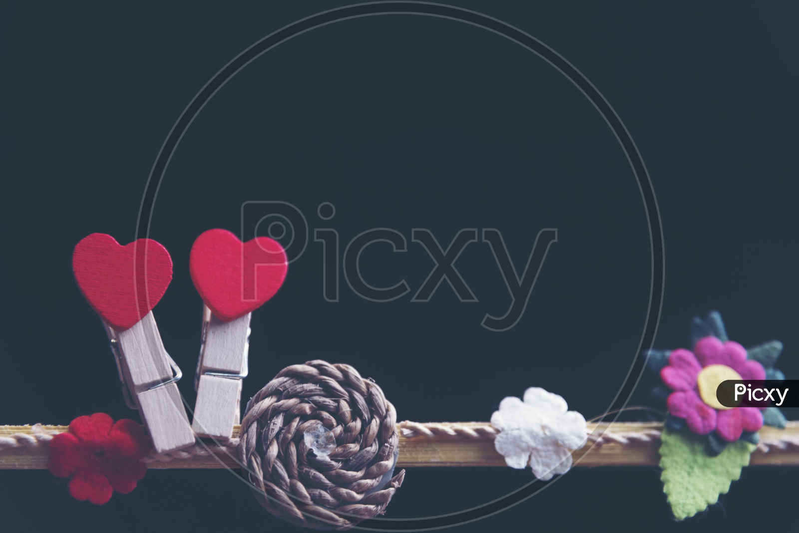 Red Heart Shapes Couple Hung Together On an Isolated Black Background  For Valentines Day Concept