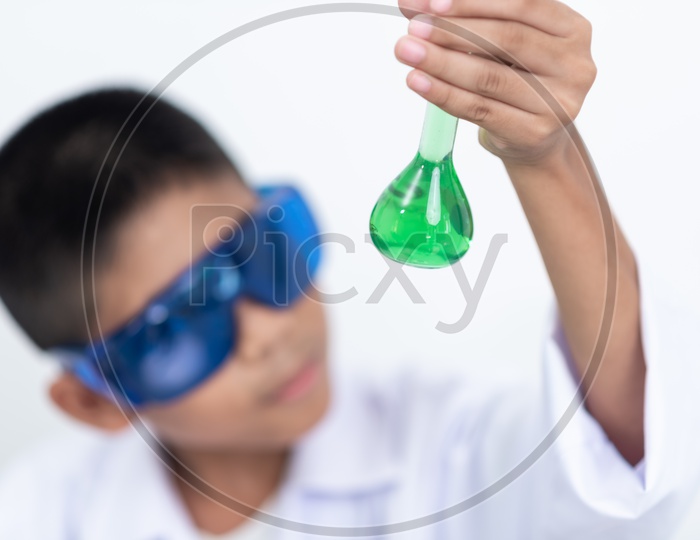 Asian Child Scientist Holding a Solution in Test Tube at Laboratory