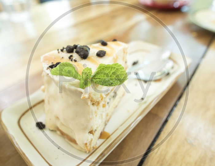 cheese cake  With Choco Chips And Mint leaf  on a Cafe Table Background