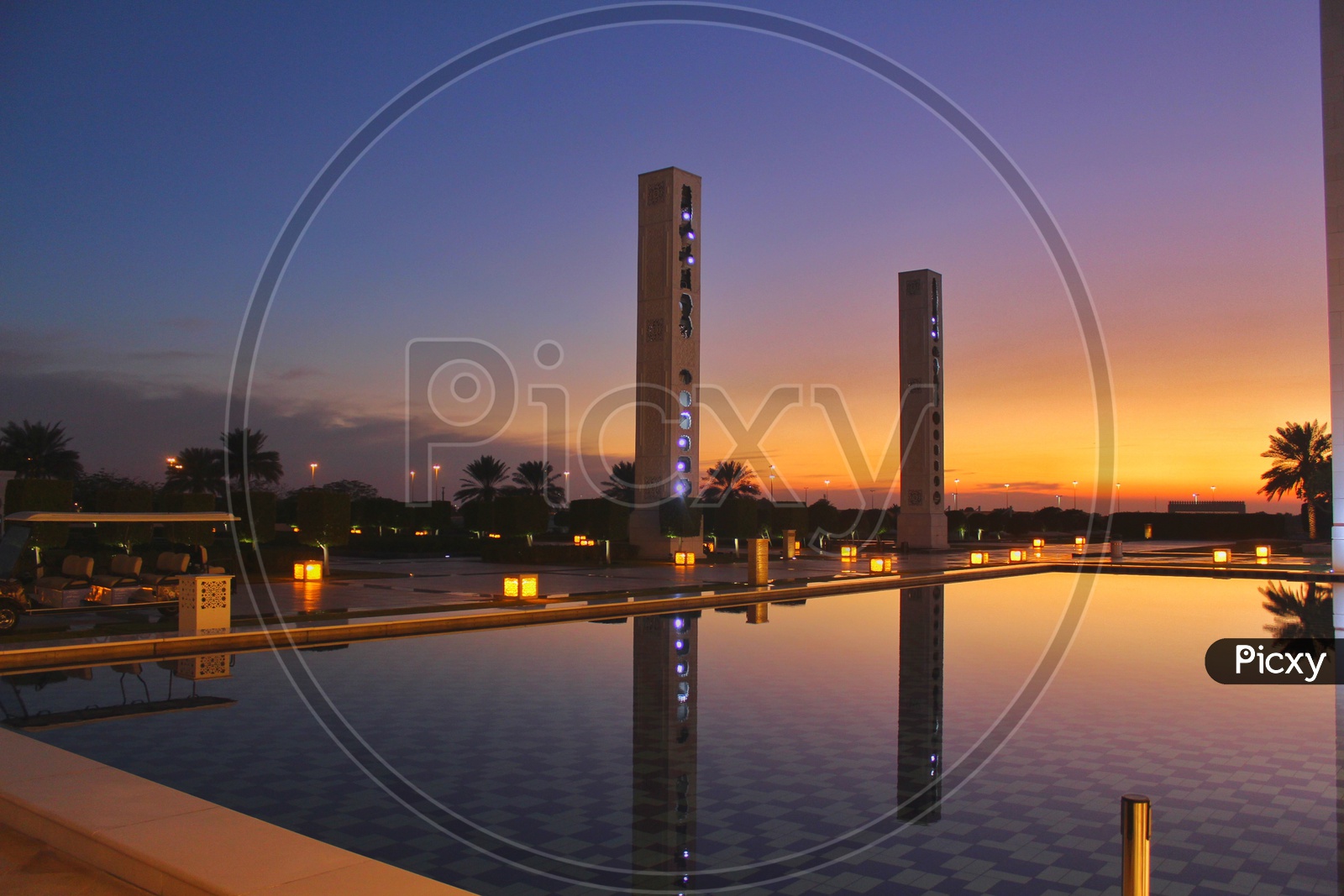 Reflection of a tall buildings in a swimming pool during sunset