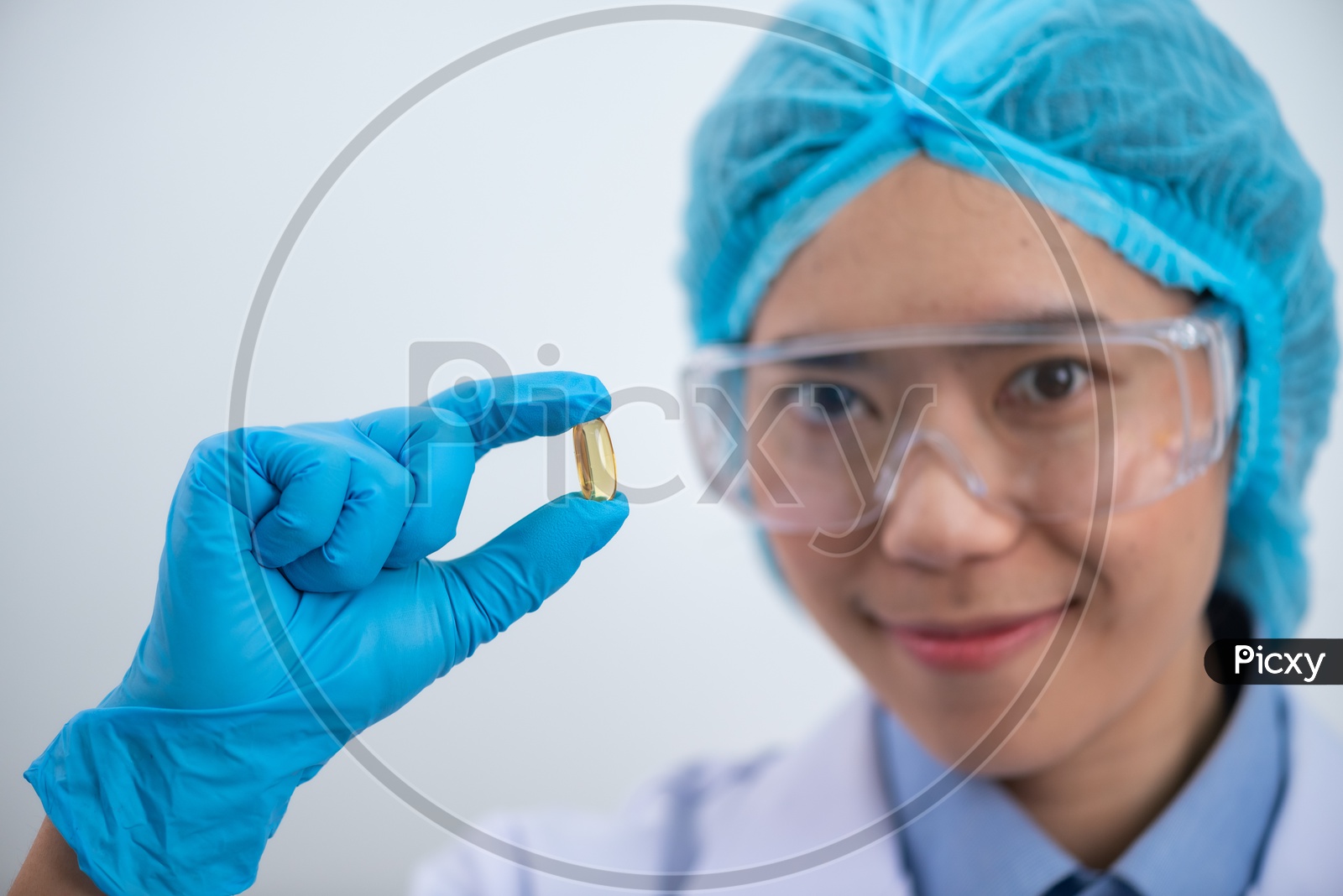 Young Asian Woman Scientist Holding Fish oil Capsule or Pill in Hand, Healthy Nutrition