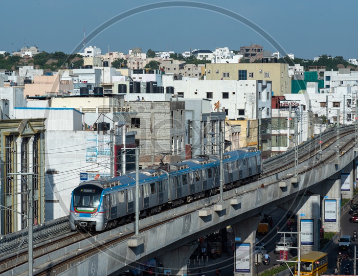 Metro train Running On Track With City scape In Background