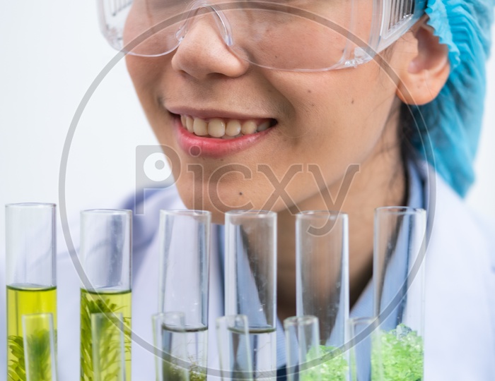 Young Asian Woman Scientist Holding Bio Fuel Solution in Test Tubes at Laboratory