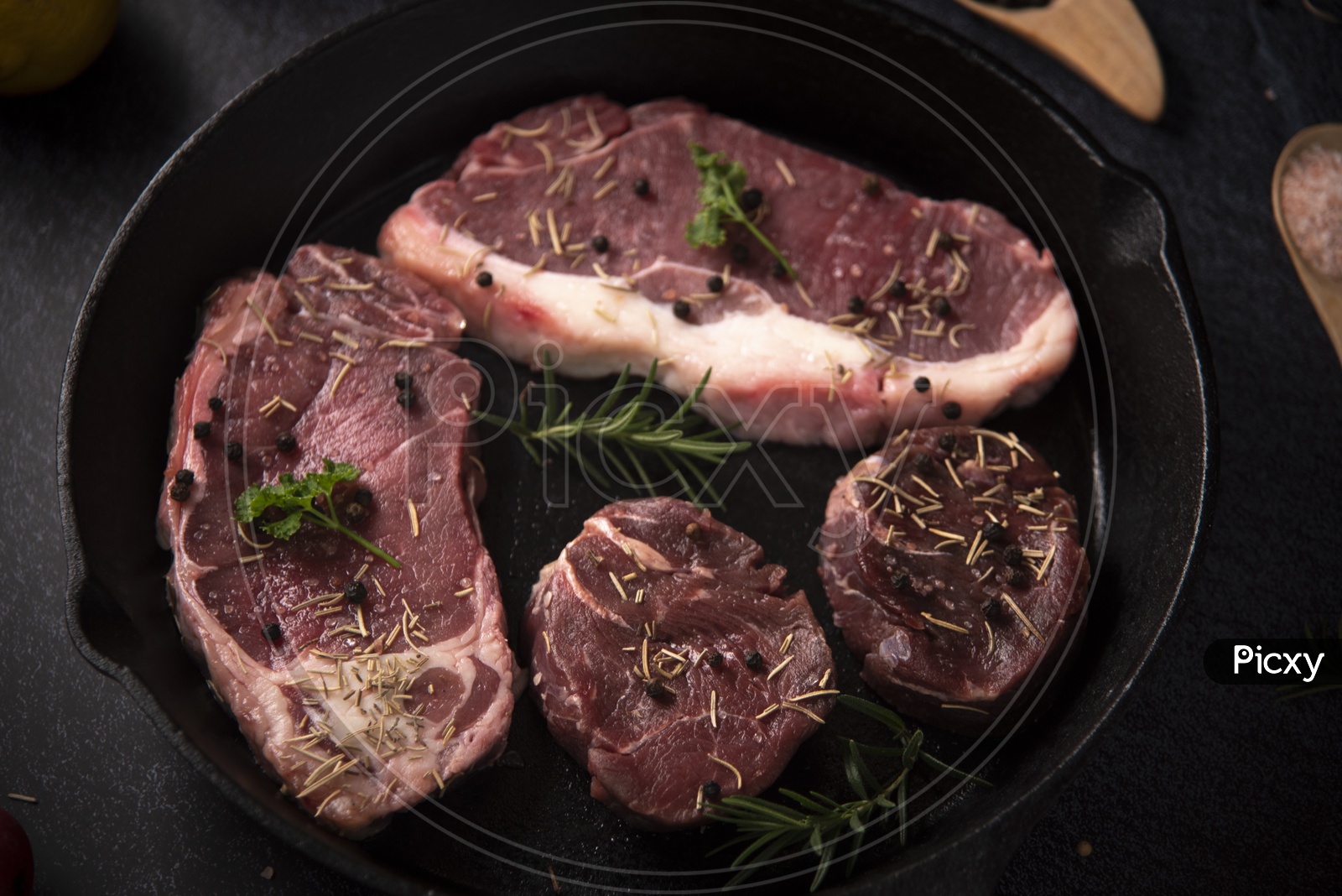 Fresh Raw Prime Black Angus Beef Steaks on Wooden Board: Tenderloin, Denver Cut, Striploin, Rib Eye