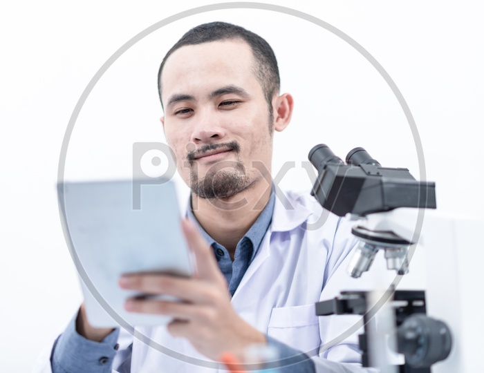 Young Asian Scientist or Medical Student working with digital tablet in laboratory