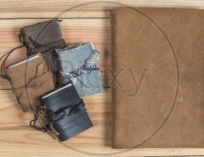 vintage craft Handmade leather book covers On wooden  Background