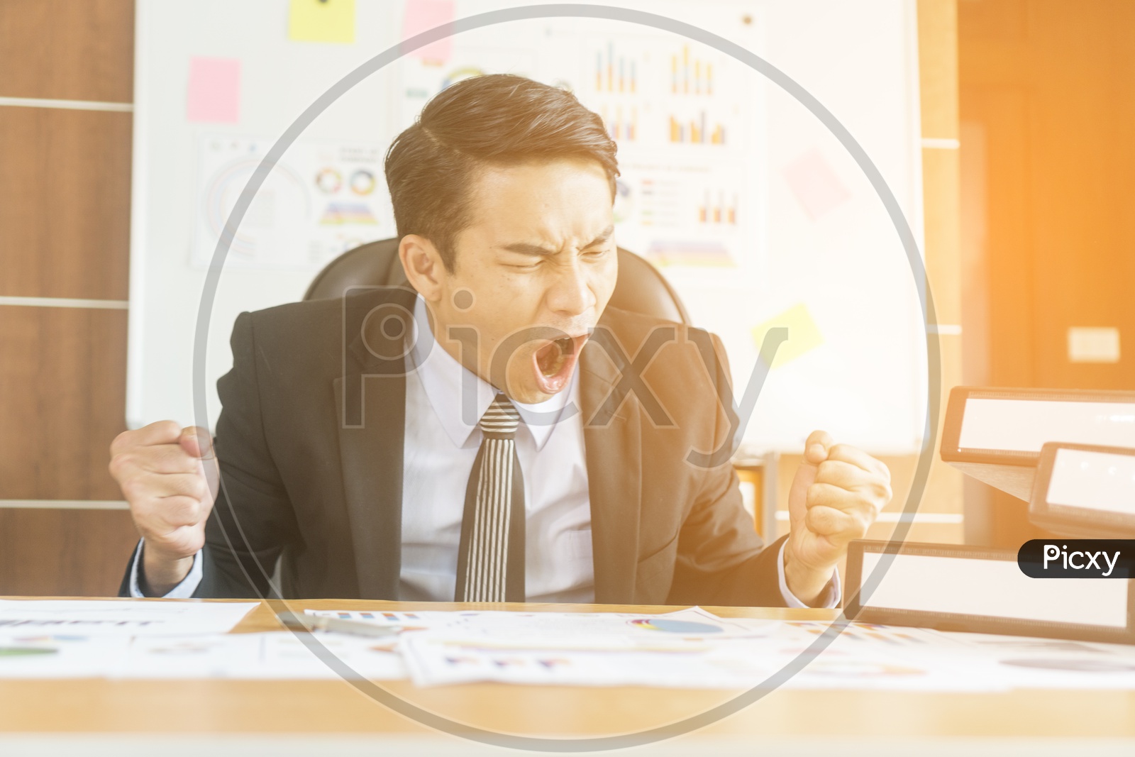 A man shouting in distress - Concept of stress and frustration of a businessman with laptop