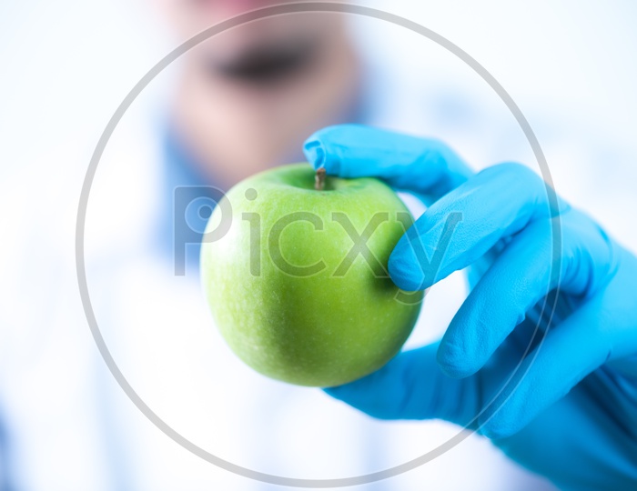 Young Asian Scientist Holding Apple in Hand at Laboratory