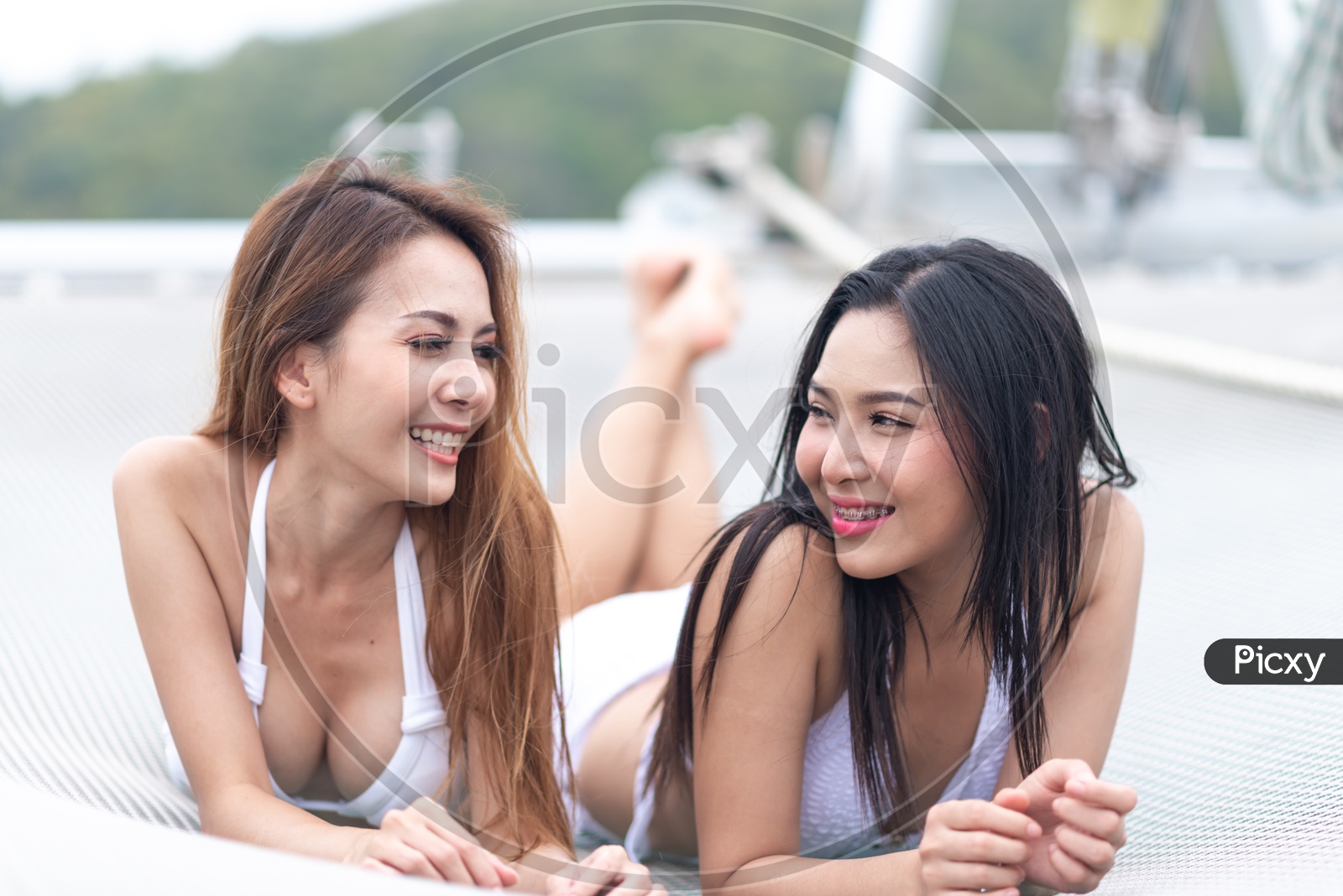 Beautiful girls in white bikini on a yacht in Sea