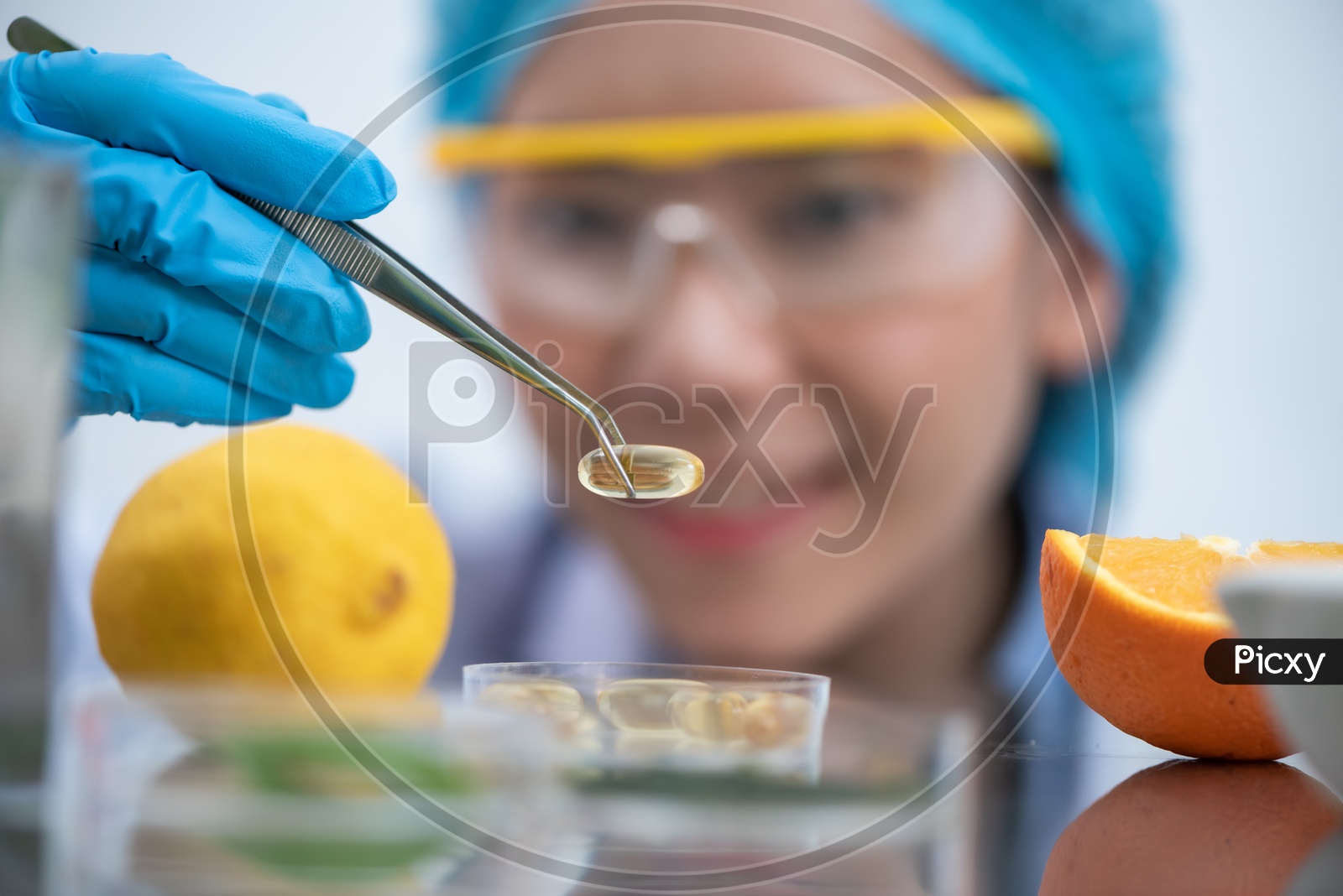 Young Asian Woman Scientist Holding Fish Oil Pill Or Capsule with Oranges in Foreground