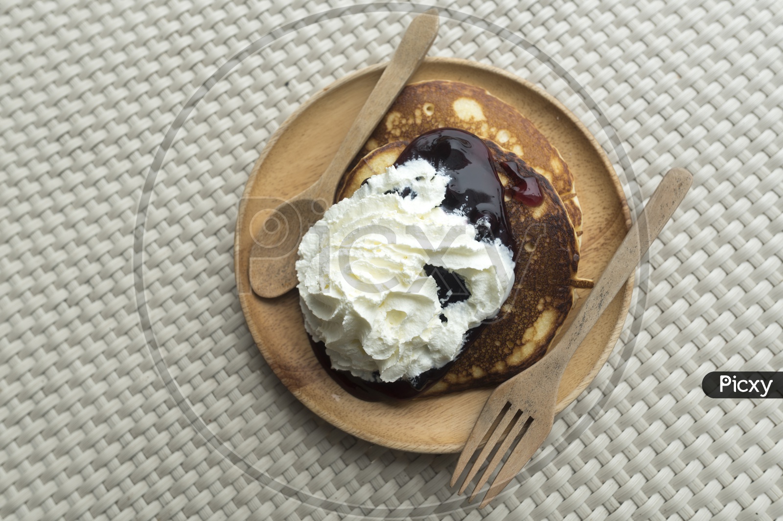 Breakfast With Pancakes Served  With Whip cream And Blueberry Jam On an Restaurant table Background