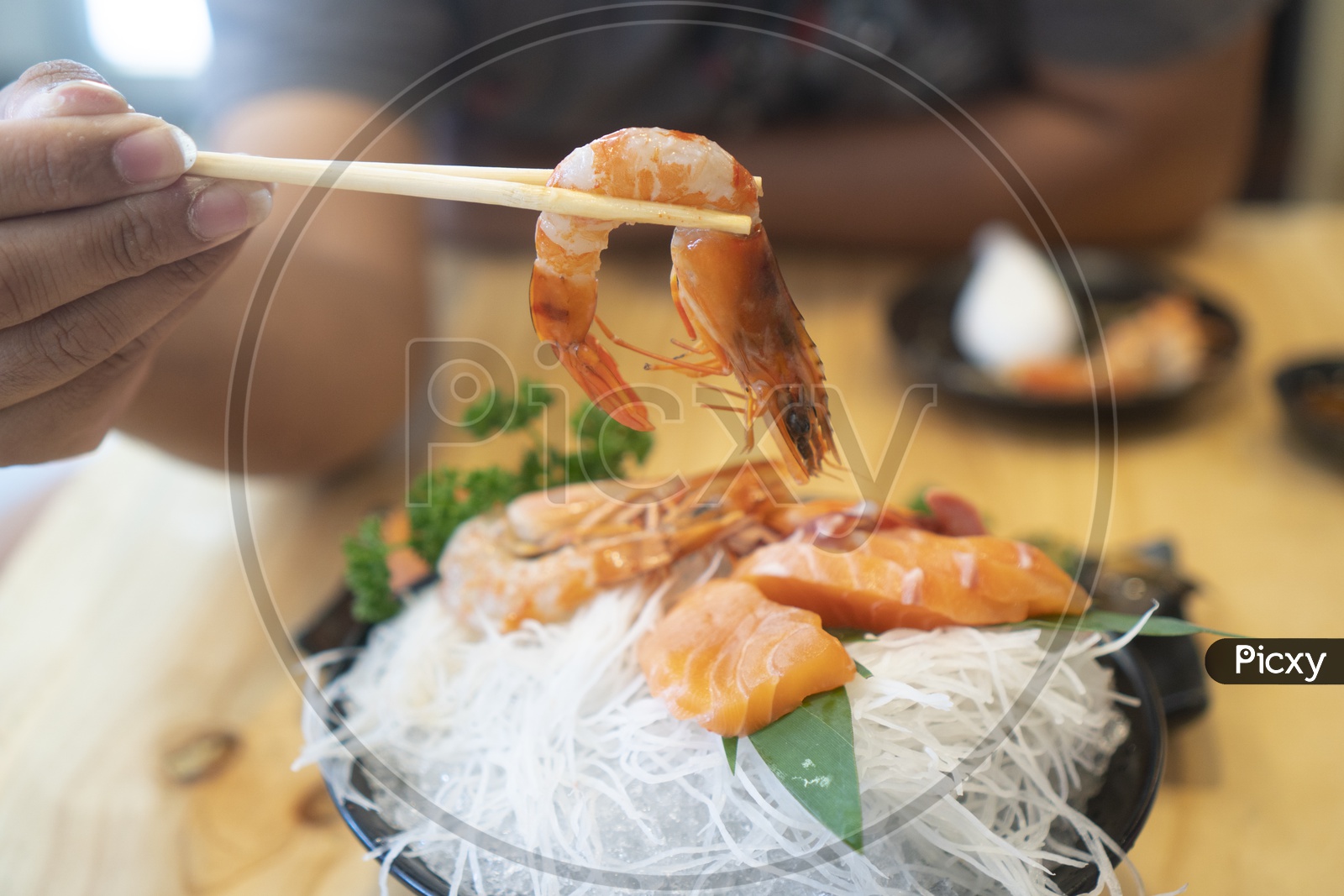 A man earting fresh Japanese sashimi set food