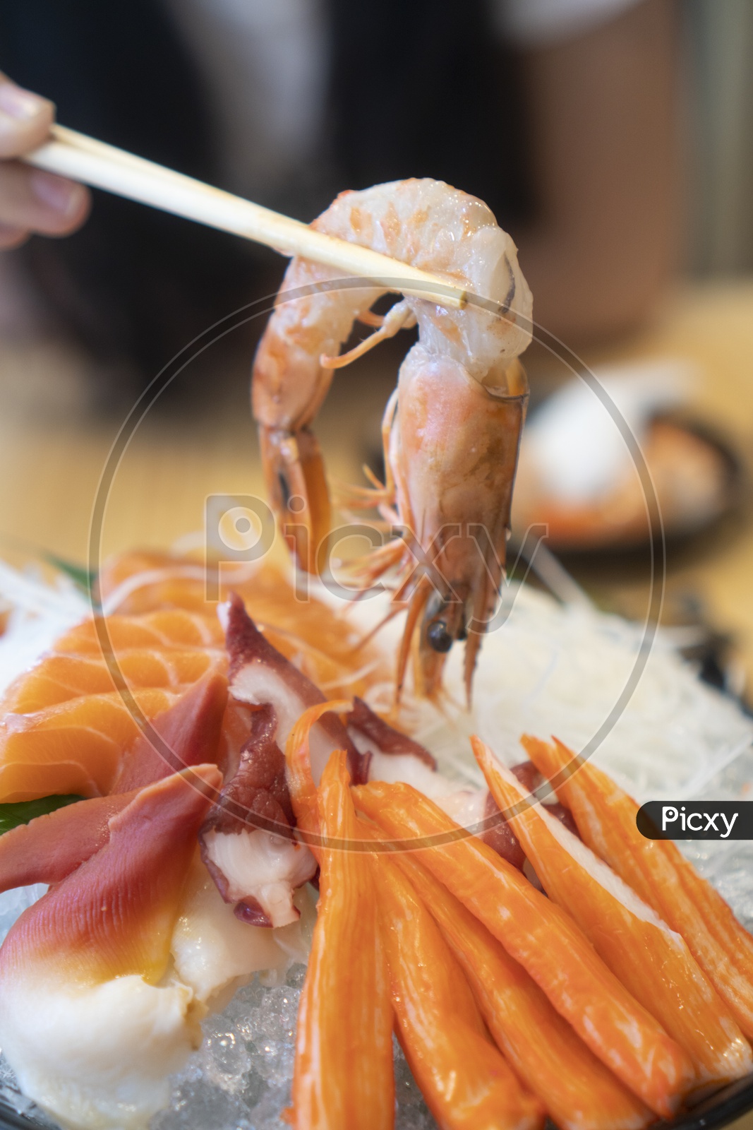 A Man eating sashimi sets Fresh quality Japanese food with Chopsticks