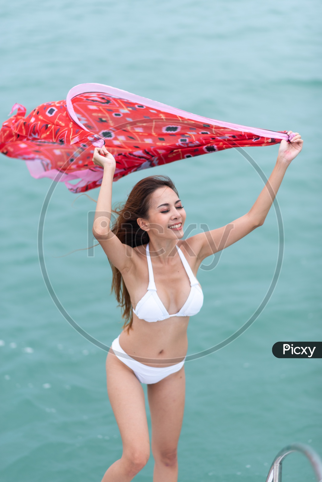 Young Asian girl in white bikini on Yacht