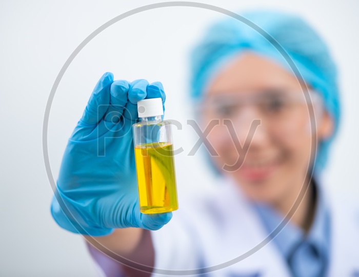 Young Asian Woman Scientist Holding Bio Fuel Solution in Test Tubes at Laboratory