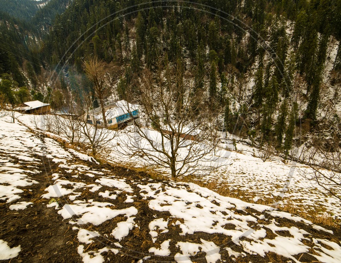 Houses Or Cottages In The Mountain Valleys Of Himalayas With Snow In Winter Season