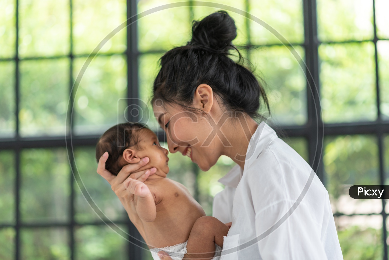A young Asian mother holding a baby