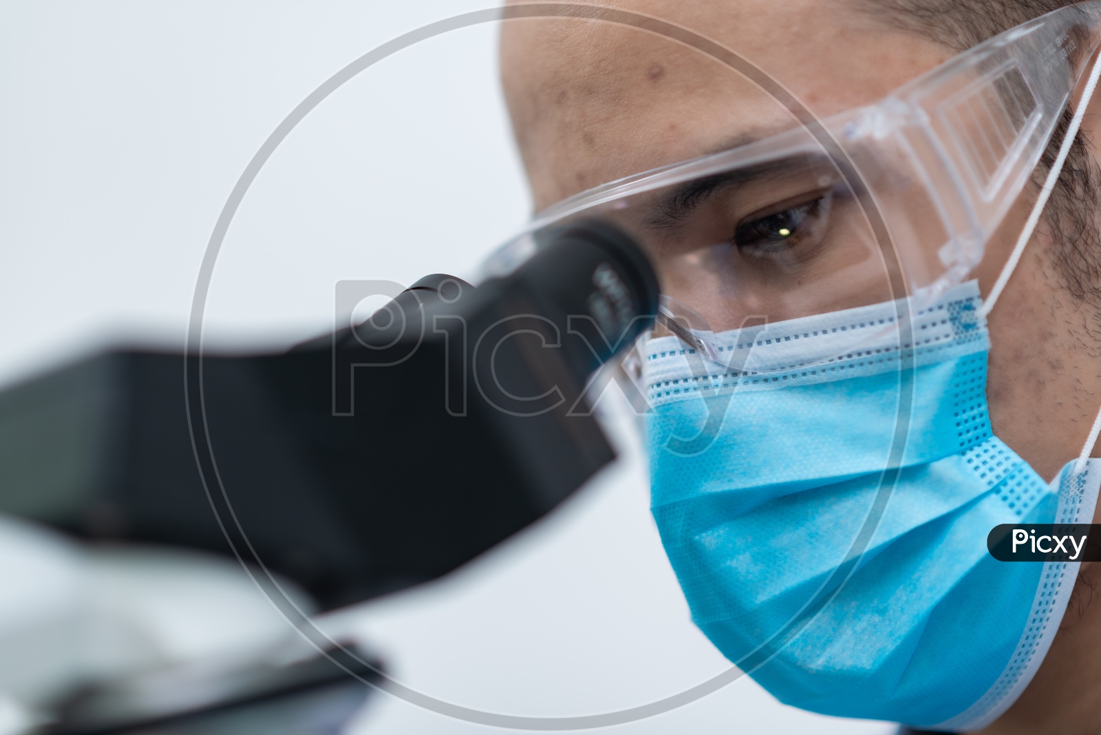 Closeup Shot of Asian Male Scientist Looking on Microscope