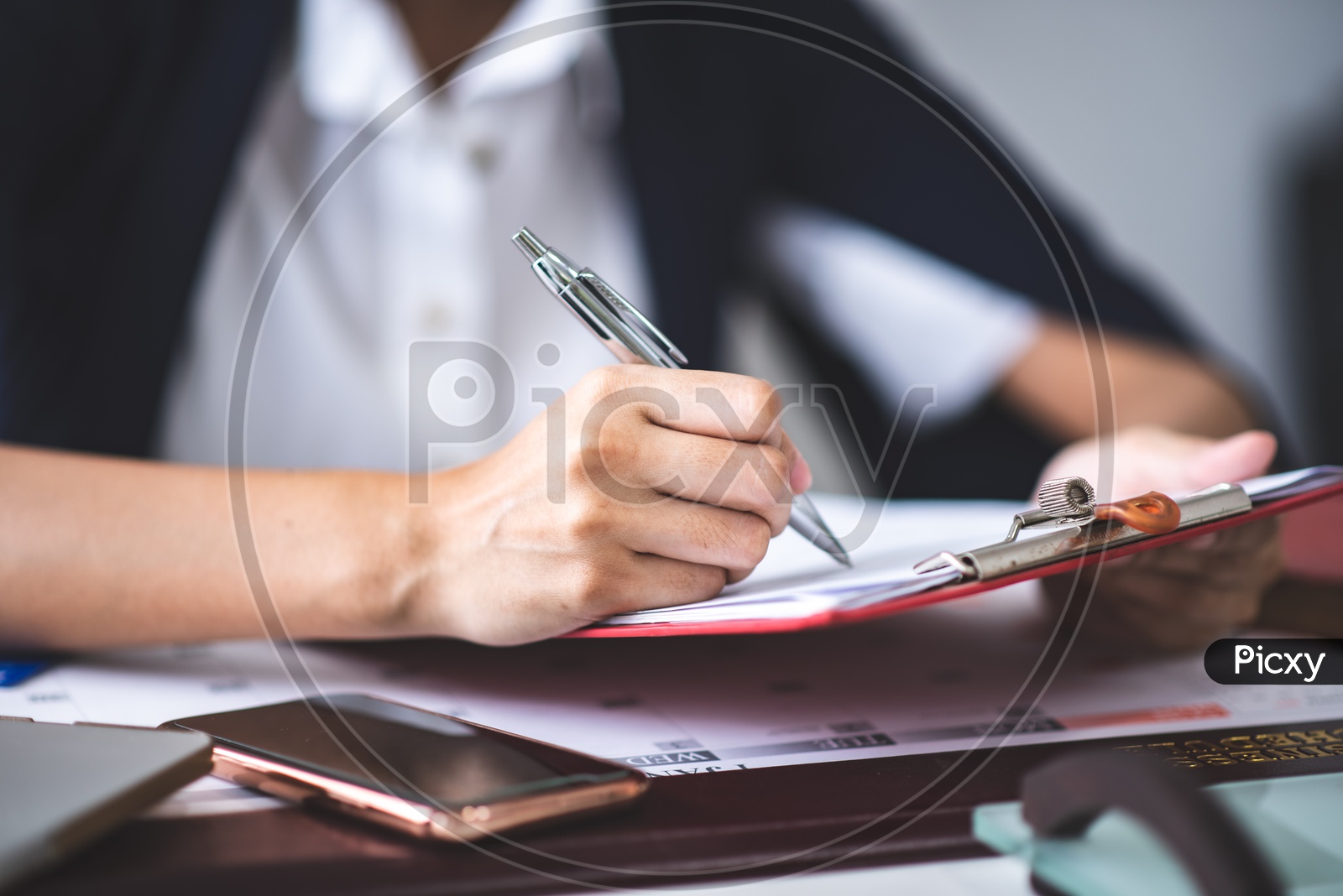 Asian Businesswoman filling Tax Documents