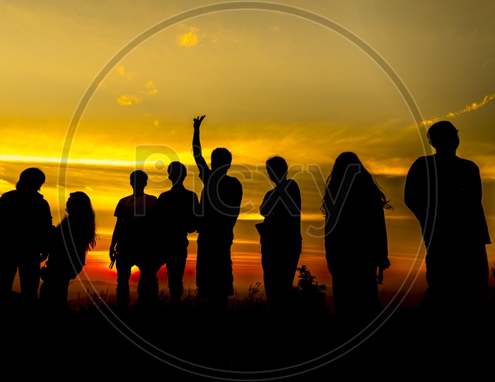 Silhouette group of people at sunset