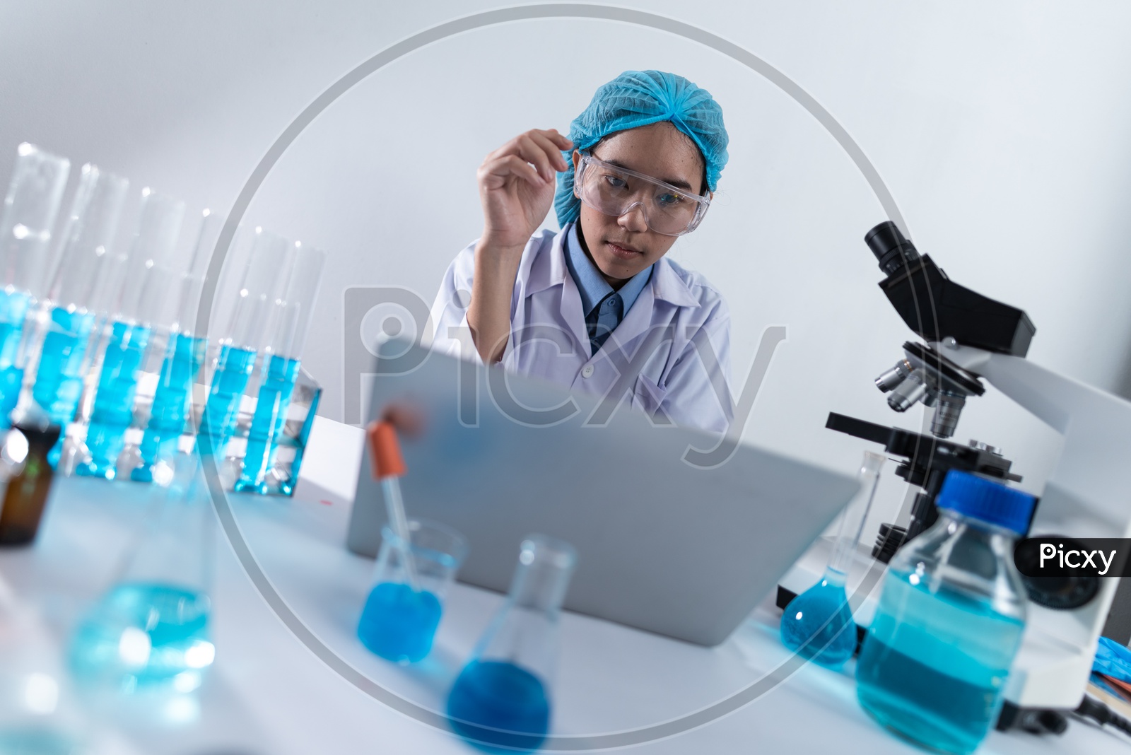Asian Woman Scientist or Medical Student Working on her Laptop at Laboratory