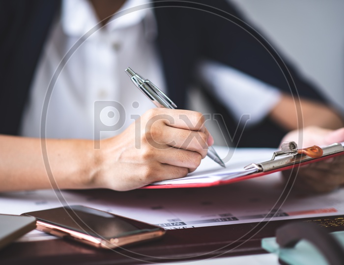 Asian Businesswoman filling Tax Documents