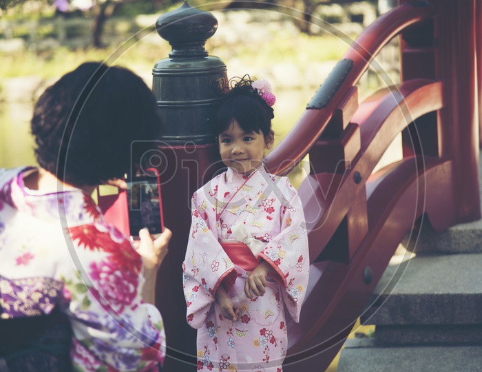 Japanese young kids taking pictures in Kyoto, Japan.