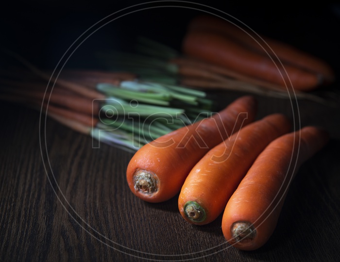 Organic Carrots on Wooden Background