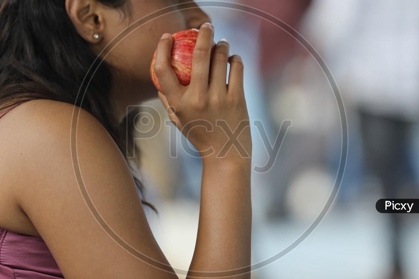 Indian Woman holding an Apple