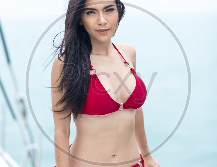 sexy women in red bikini on yacht boat